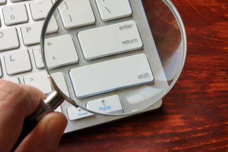 Online crimes and investigation concept. Magnifier and keyboard.の写真素材