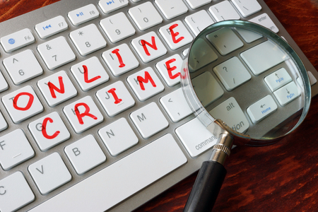 Online crime written on a keyboard.の写真素材