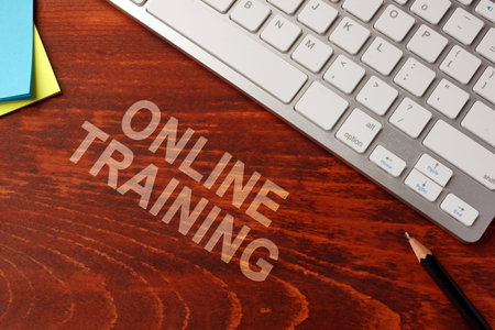 Online training written on a wooden surface. E-learning concept.の写真素材