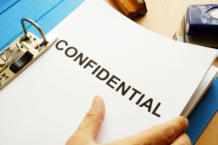 Documents with title Confidential on a table.の写真素材