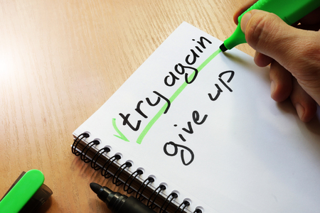 Try again or give up written by hand.の写真素材