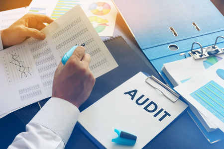 Document with title Audit on an office table.