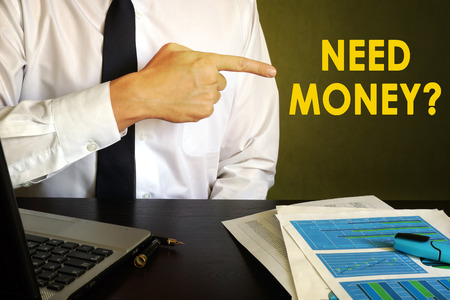 Businessman pointing at sign need money. Loans concept.の写真素材