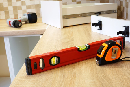 Installation of furniture in the kitchen. Assembly of cabinets.の写真素材