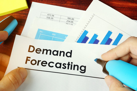 Man holding documents with name Demand Forecasting.の写真素材