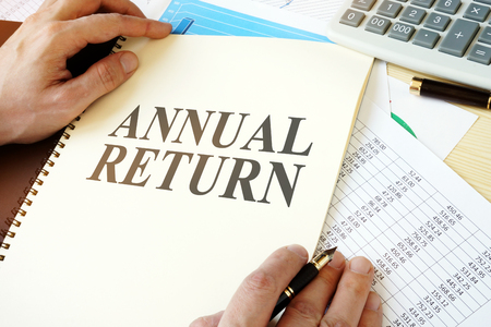 Man holding document with title Annual return.の写真素材