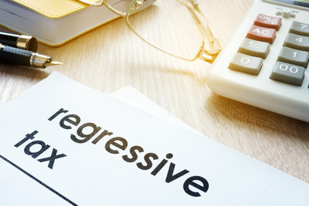 Documents about regressive tax on an office table.の写真素材