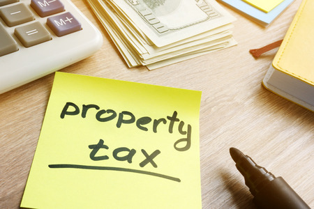 Memo stick with words property tax and money.の写真素材