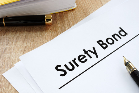 Surety bond form and pen on a table.の写真素材