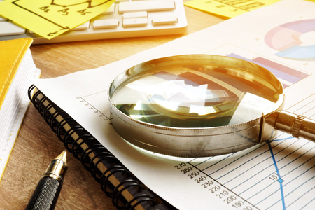 Business assessment and audit. Magnifying glass on a financial report.の写真素材