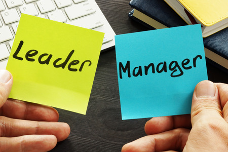 Leader vs manager. Man is holding memo sticks.の写真素材