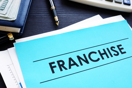 Documents with title franchise on a desk.の写真素材