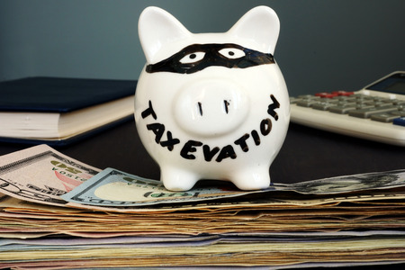 Tax evasion written on a piggy bank.の写真素材
