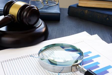 Financial crime. Gavel and Magnifying glass with business documents. Fraud.の写真素材