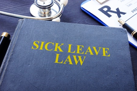Sick Leave Law book and the stethoscope.の写真素材