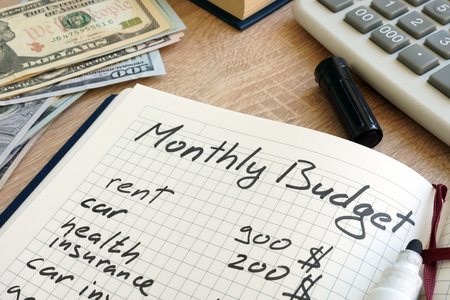 Note pad with monthly budget calculations and money.の写真素材