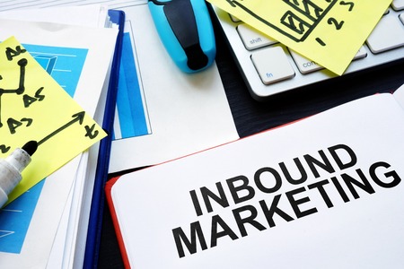 Inbound marketing. Book, reports and pen on table.の写真素材