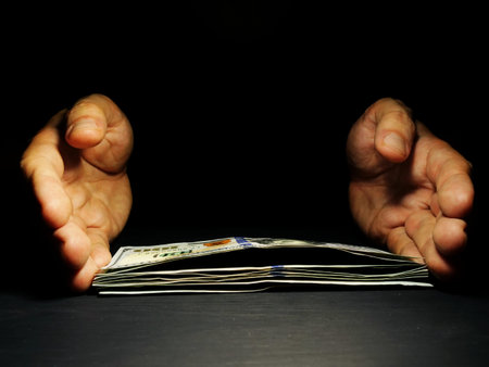 Hands offer money in the dark Free space. Lending and loan concept.