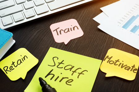 Staff hire, train, motivate and retain written on a memo sticks.の写真素材