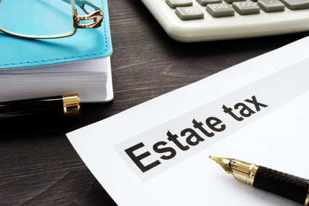 Estate tax and gavel on a wooden desk.の写真素材