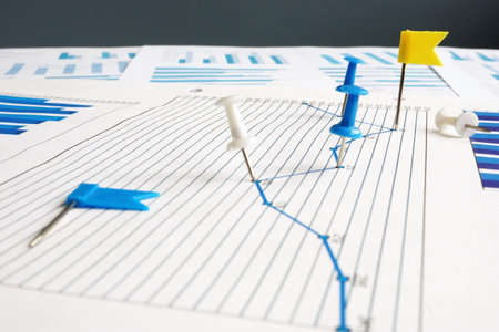 KPI key performance indicators. Thumb tacks and business papers.