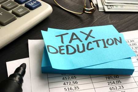 Tax deduction written on a piece of paper.の写真素材