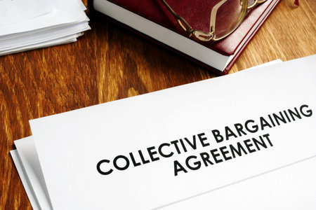 Collective bargaining agreement and note pad with glasses.