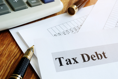 Documents about tax debt on a table.の写真素材