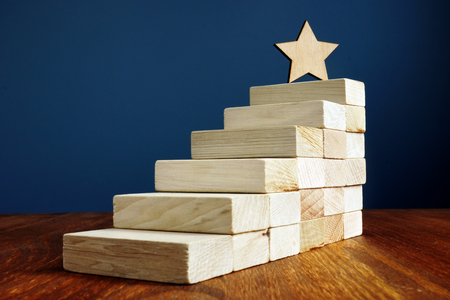 Goal setting and achievement. Star and stairs from wood.の写真素材