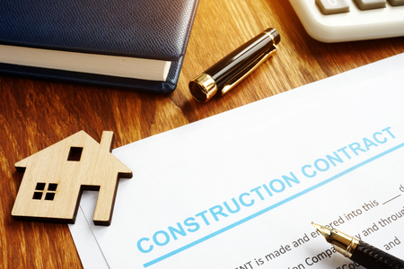 Construction contract, model of house and calculator.の写真素材