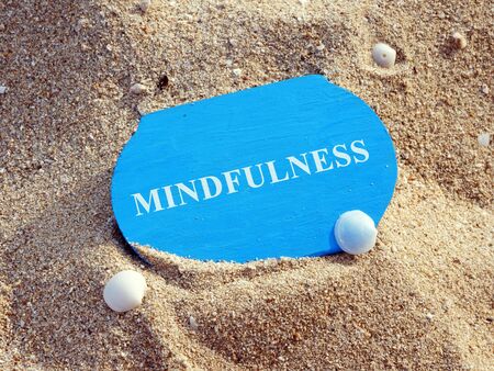 Mindfulness concept. Wooden plate on sand.の写真素材