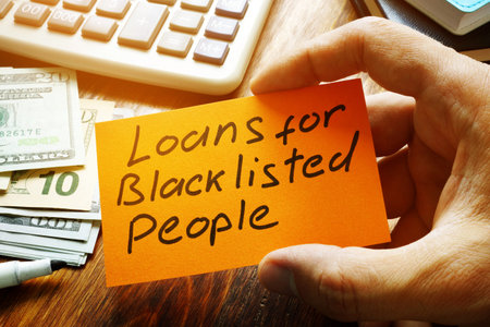 Man holds sign Loans for Blacklisted People.