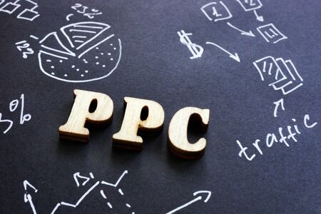 PPC pay per click sign on black paper.の写真素材