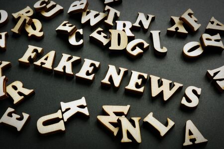 Fake news concept. Letters on the black desk.の写真素材