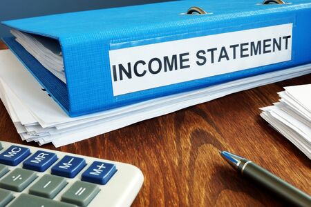 Income statement papers in the blue folder.の写真素材