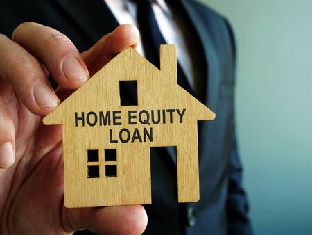 Home Equity Loan sign on a wooden model of house.の写真素材