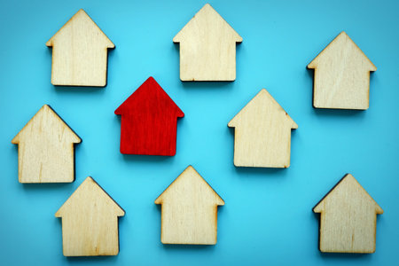 Wooden models of house and red one. Home Estimates concept.