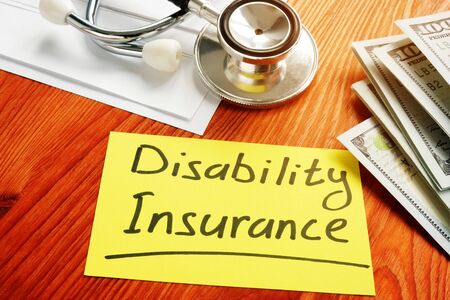 Disability Insurance memo sign with money.の写真素材