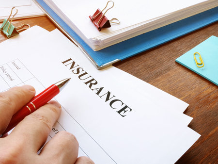 Man reads insurance form for signing.の写真素材