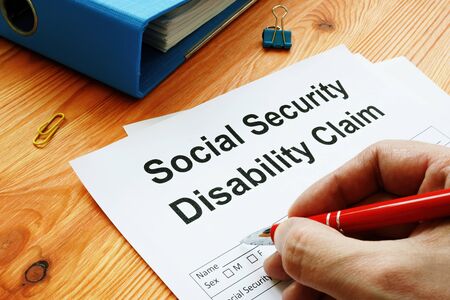 Man filling in Social Security Disability Claim.の写真素材