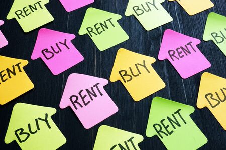 Figures of home and signs buy or rent property.の写真素材