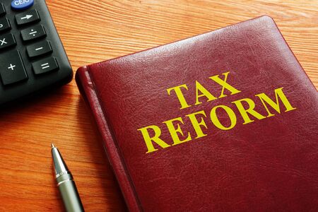 Tax Reform book with calculator and pen.の写真素材