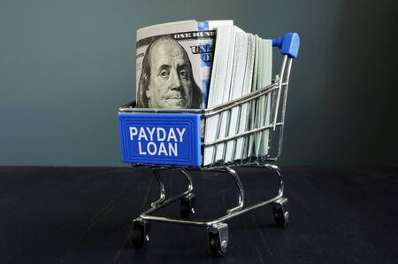 Payday loan sign, money and shopping cart.の写真素材