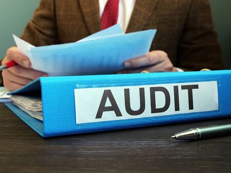Internal financial audit. Auditor with folder and papers.の写真素材