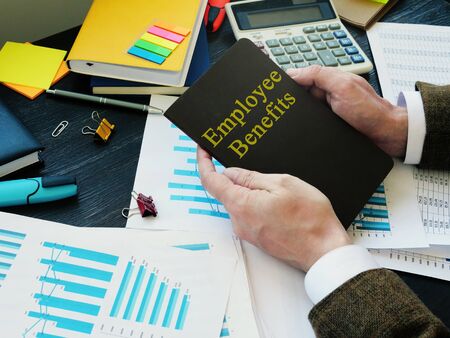 Businessman holds Employee Benefits Program.の写真素材