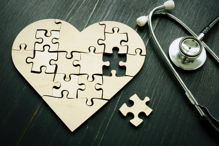 Heart disease like heart attack concept. Puzzle and stethoscope.