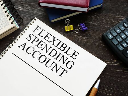 Flexible Spending Account FSA and notebooks on wooden surface.の写真素材
