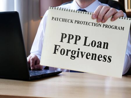 Accountant shows form for PPP loan forgiveness.の写真素材