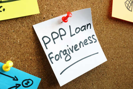 PPP loan forgiveness memo on the board.の写真素材
