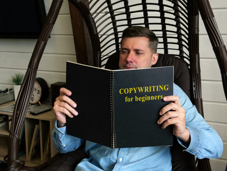 Copywriting for beginners. A man is reading a guide at home.